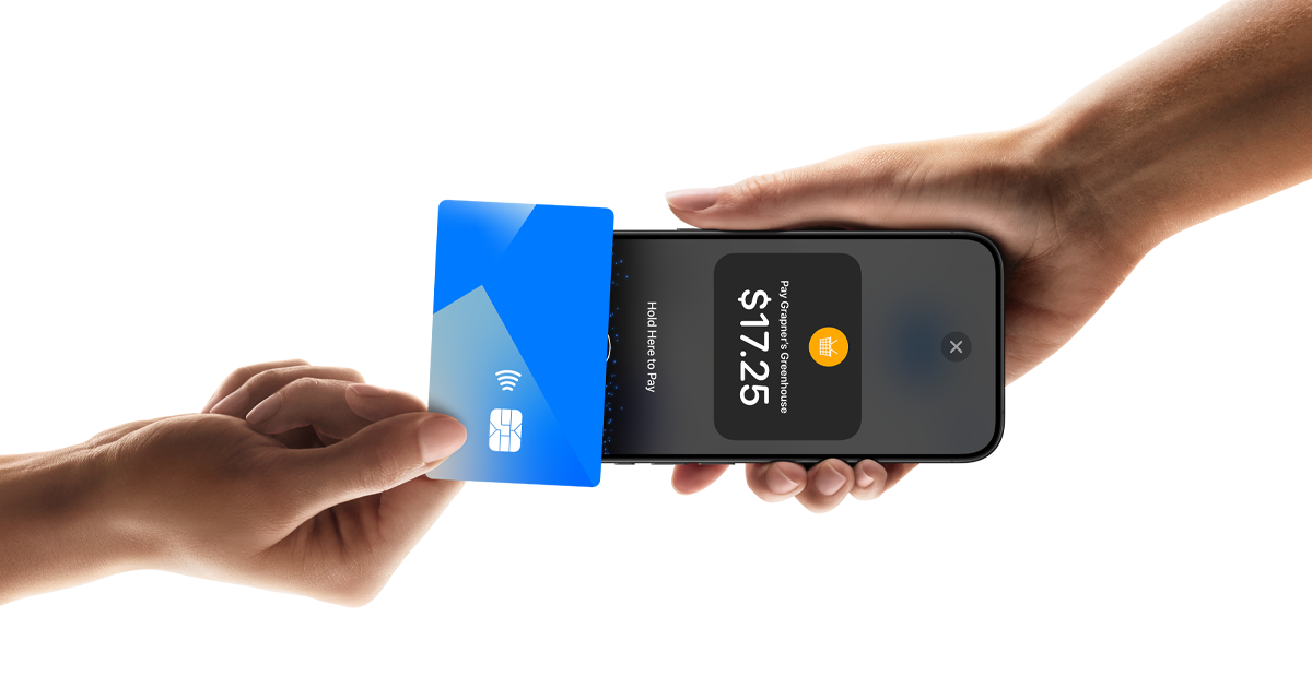 A hand holds a phone displaying a contactless payment screen for $17.25 while a second hand taps a blue bank card against the top of the handset